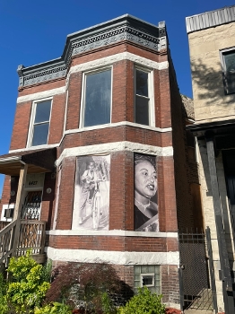 brick row house exterior with large photographs in front bay windows of Emmett Till and Mamie Till-Mobley